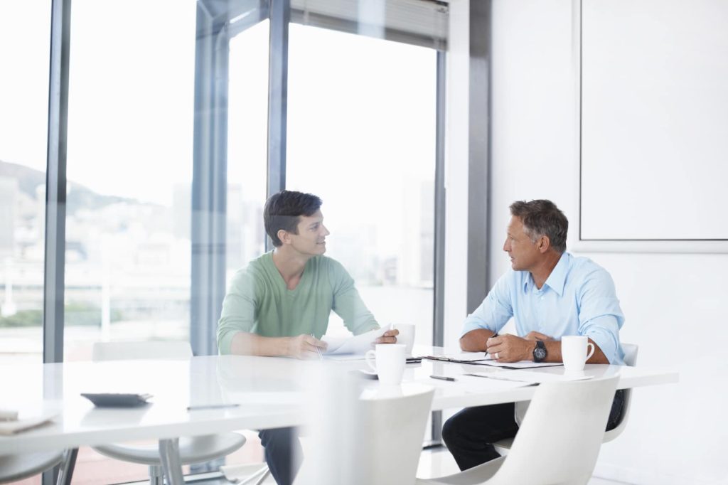 Two business men talking to each other