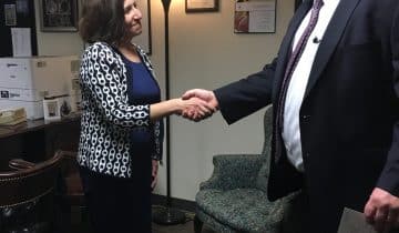 Eileen shaking hands with Hogan