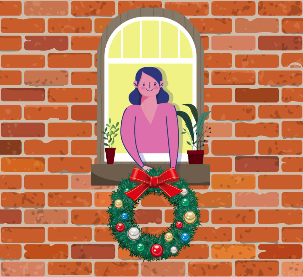 woman hanging wreath on house